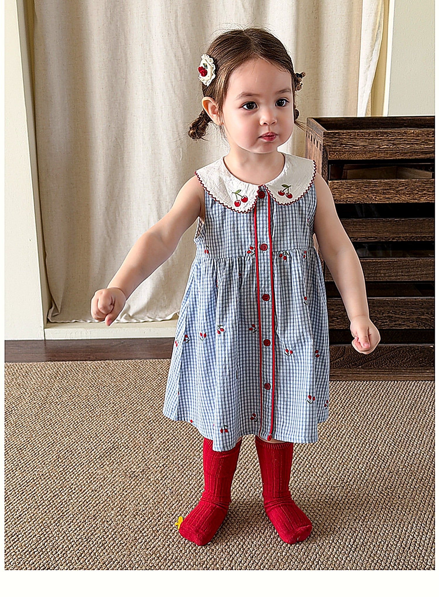 A young girl in the blue Bluebell Pinafore on a warm summer day.