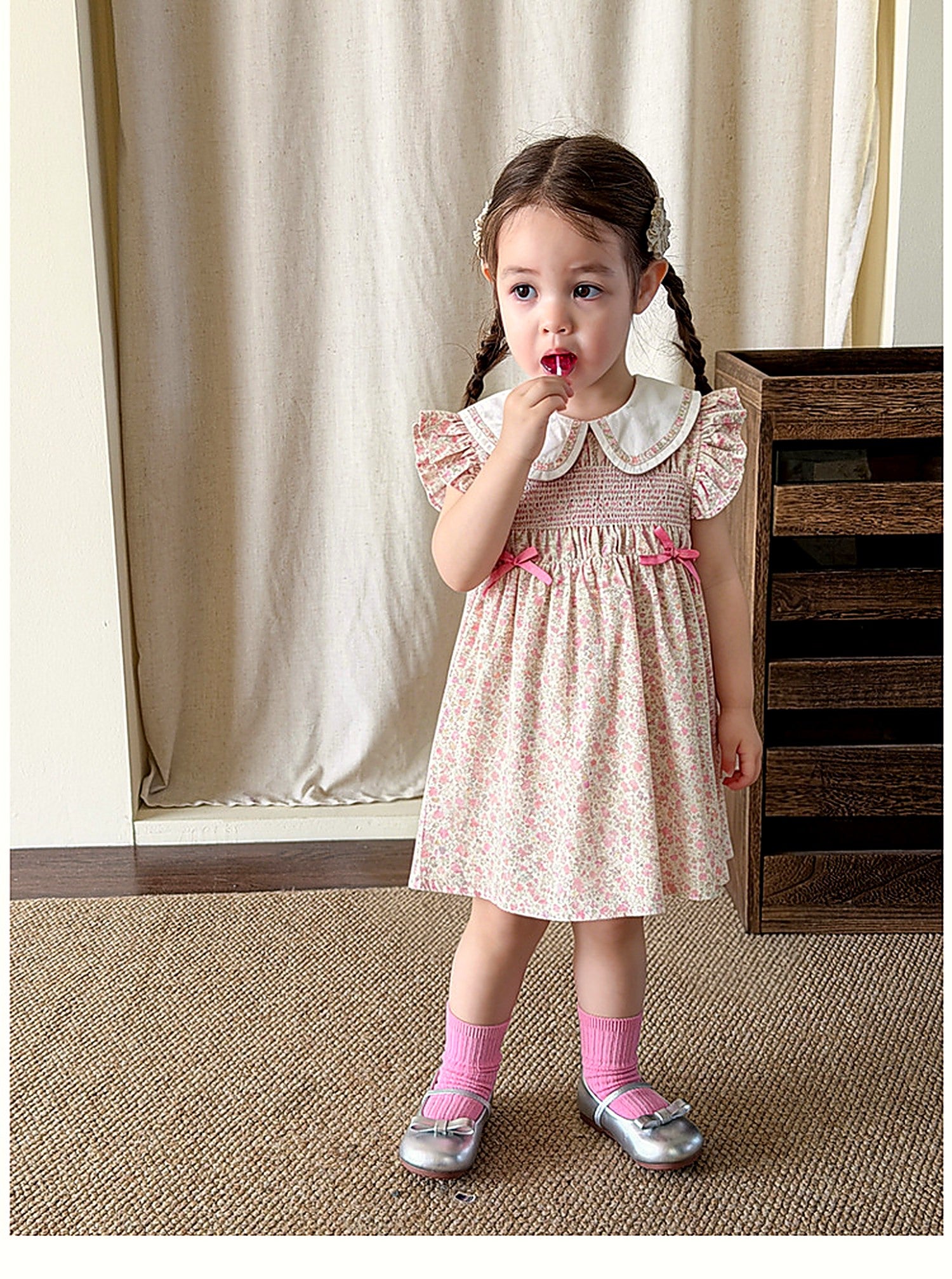 A girl in the Campion Dress, a vintage warm-pink summer dress.