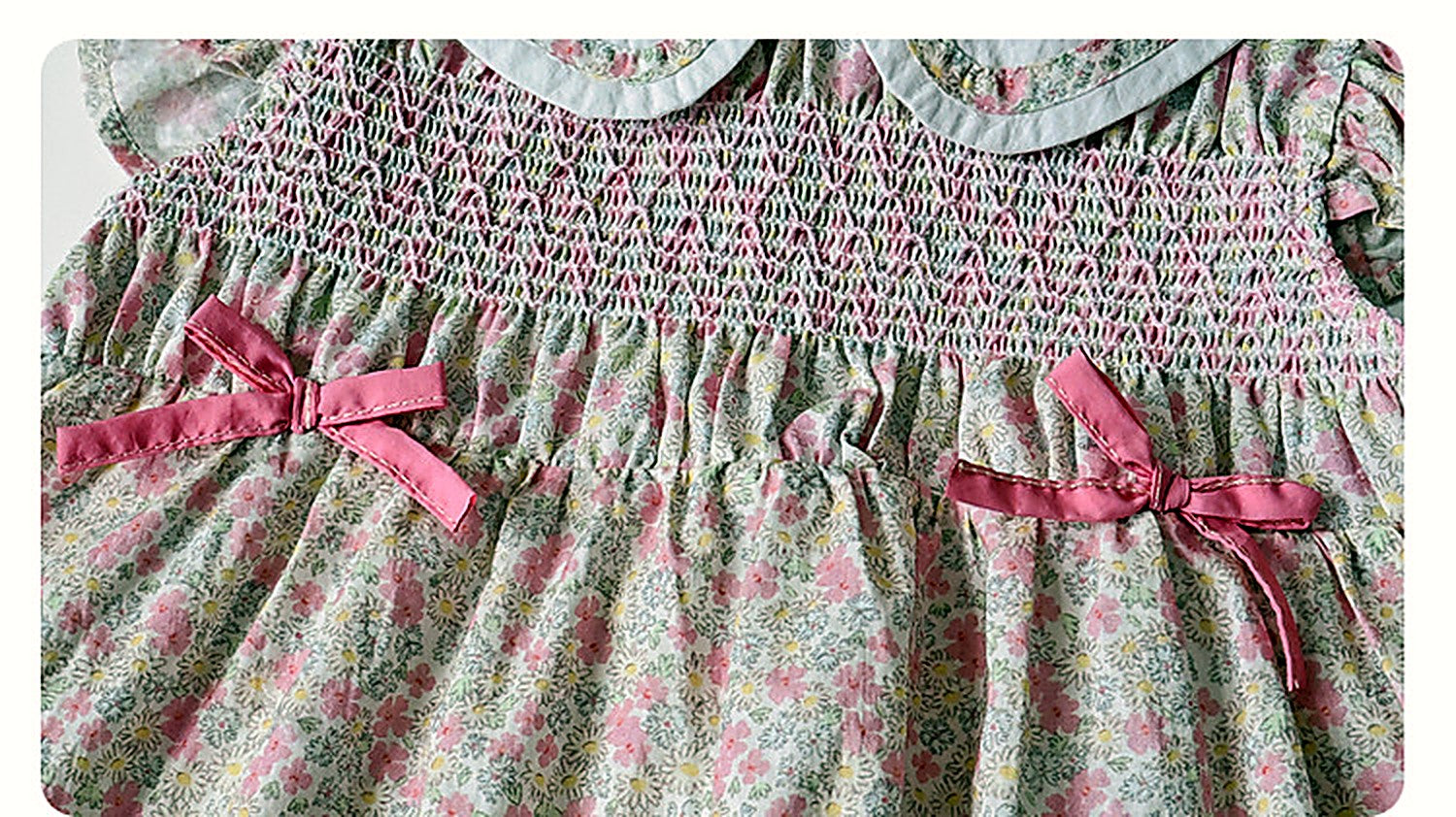 Close detail of the smocked bodice and little bows of the Campion Dress.