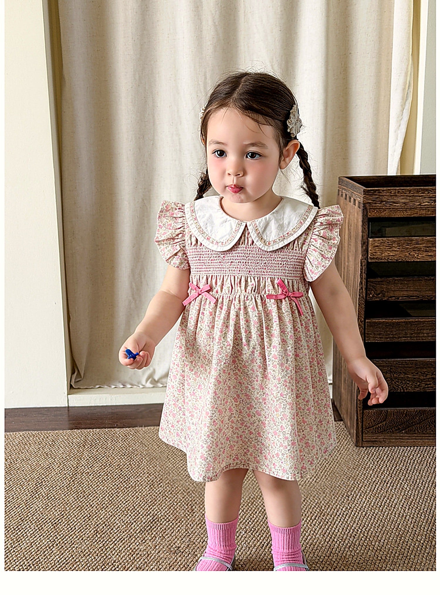 A toddler in the Campion Dress, soft afternoon light.