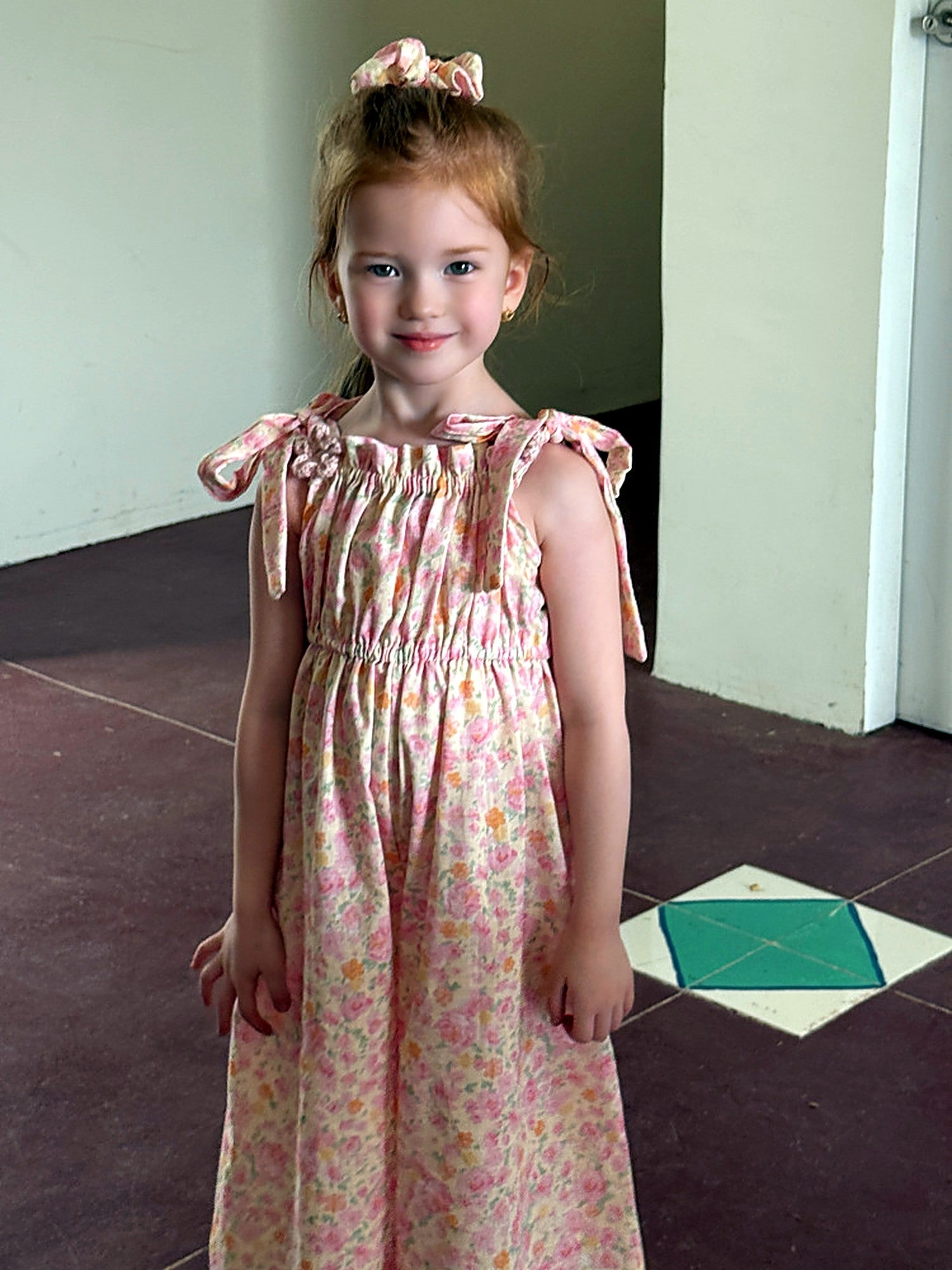 The pink ditsy floral print of the Clover Romper.