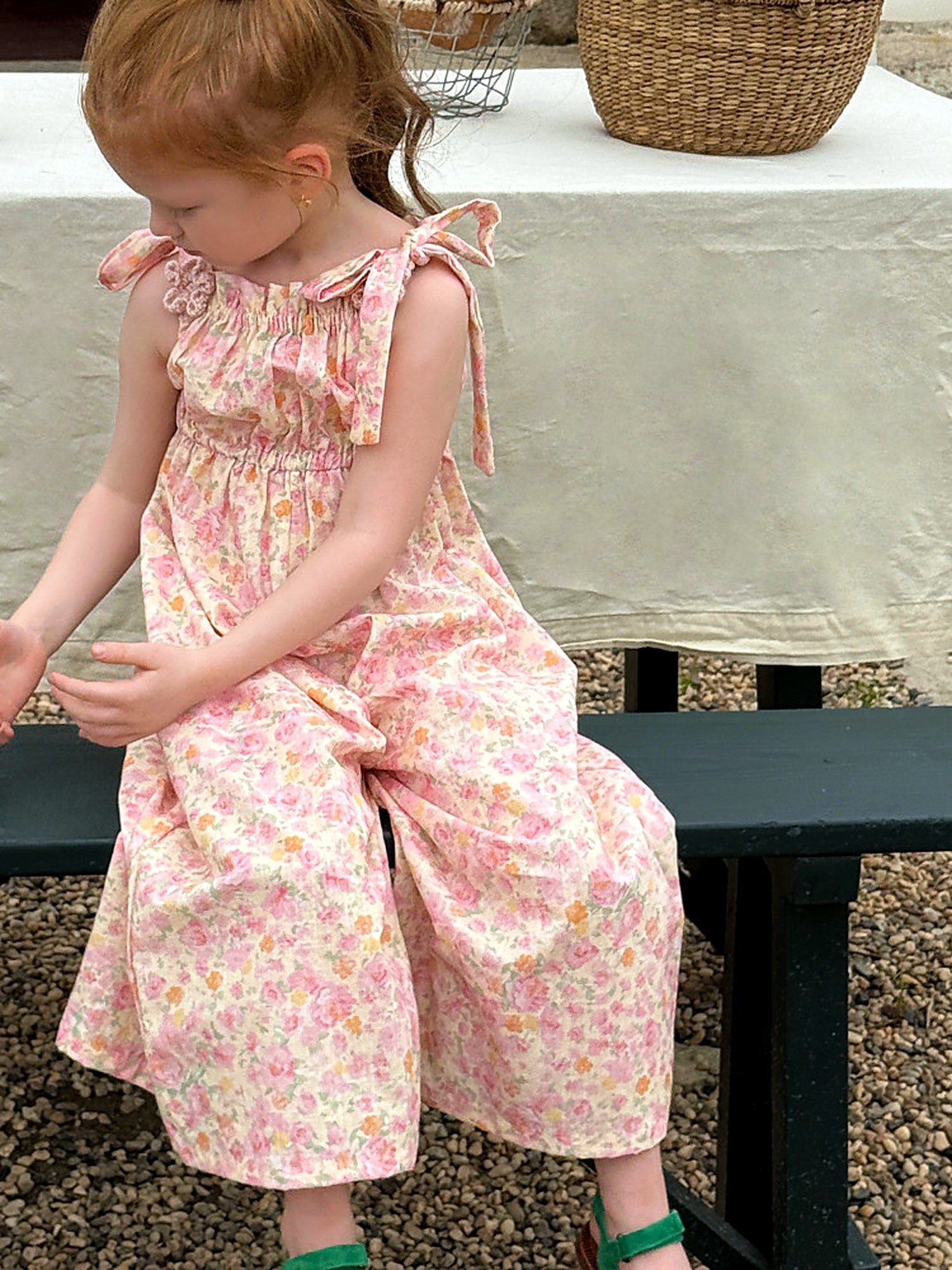 The wide legs of the Clover Romper in washed pink cotton.