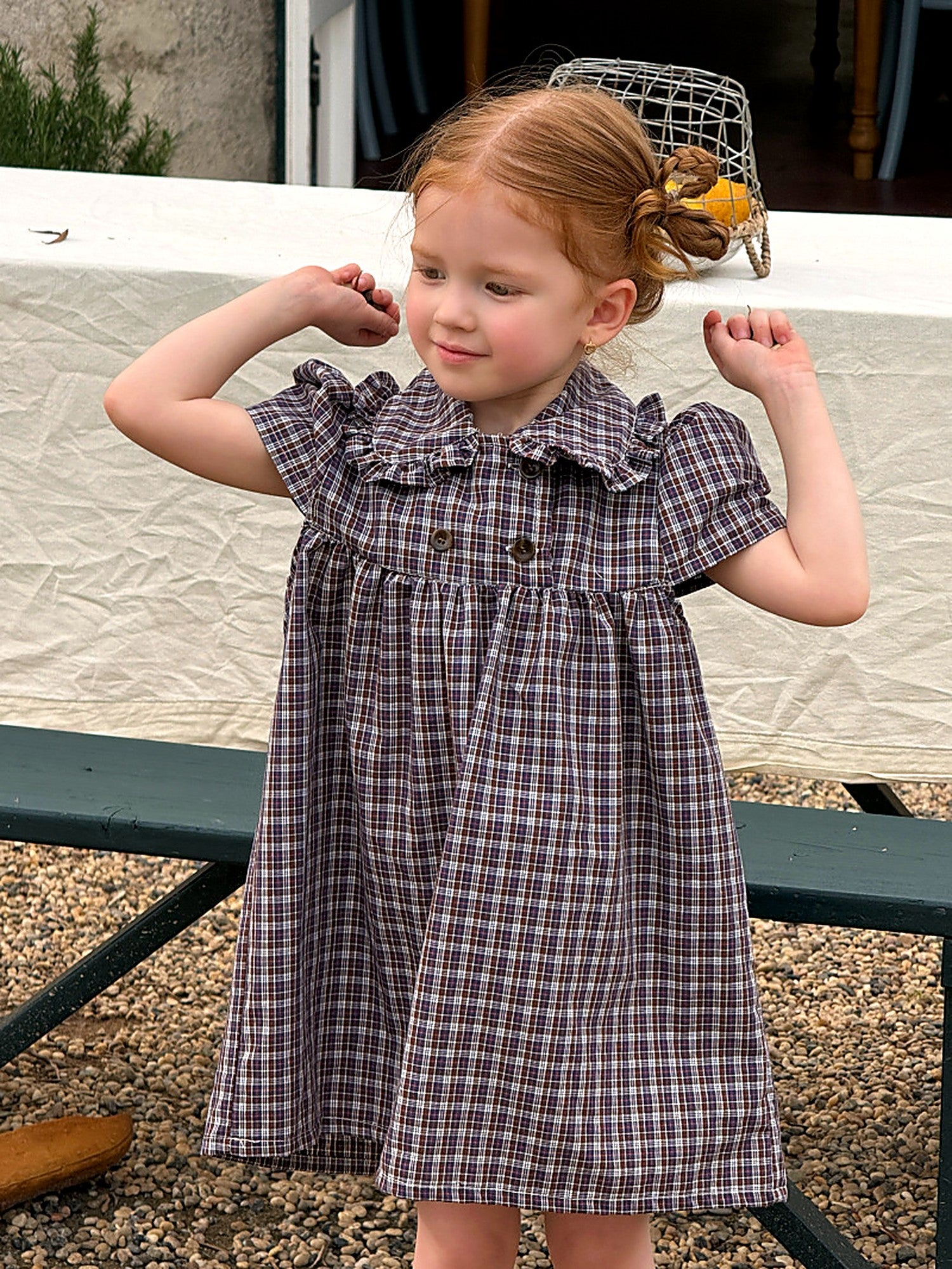 A girl in the blue check Cornflower Dress on a warm summer day.