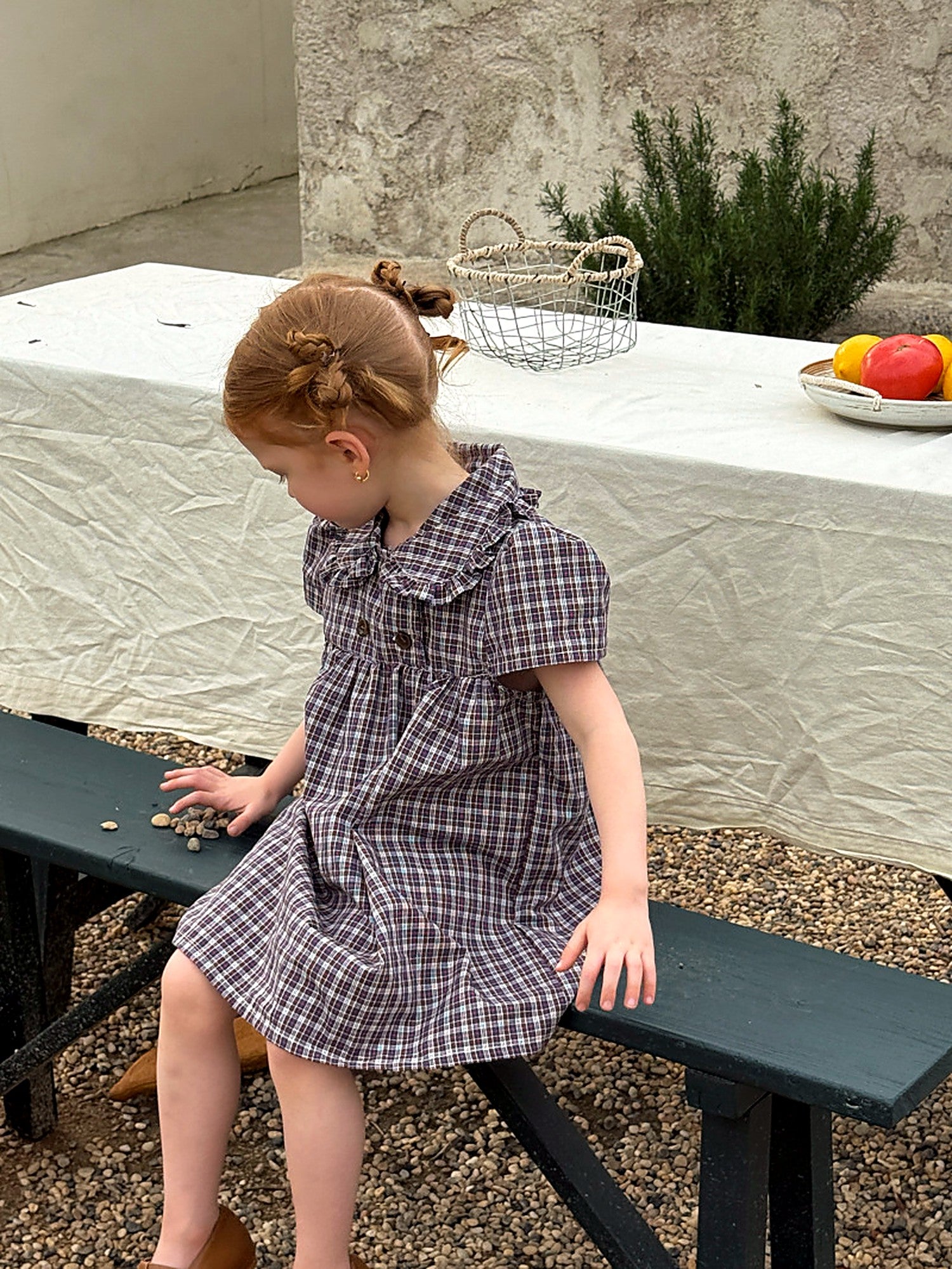 A girl moving in the Cornflower Dress, the gathered skirt swinging.