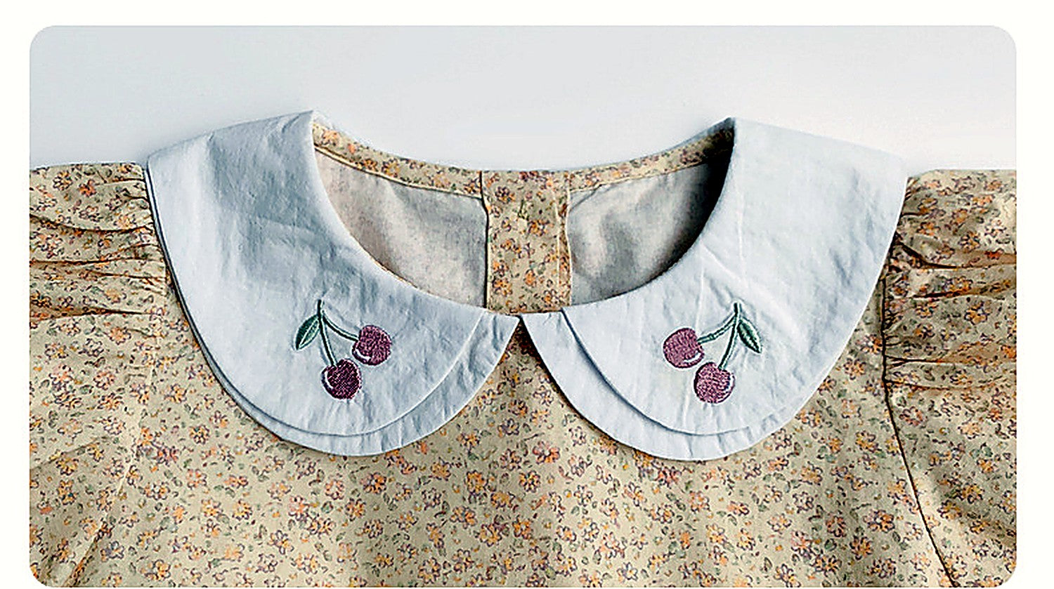 Close detail of the embroidered collar of the Cowslip Dress.