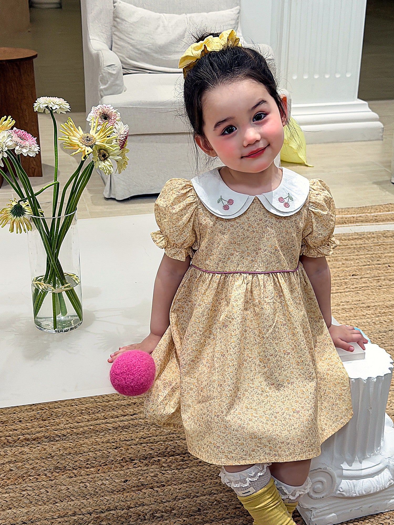 Front of the Cowslip Dress — embroidered collar and puff sleeves in butter-yellow cotton.