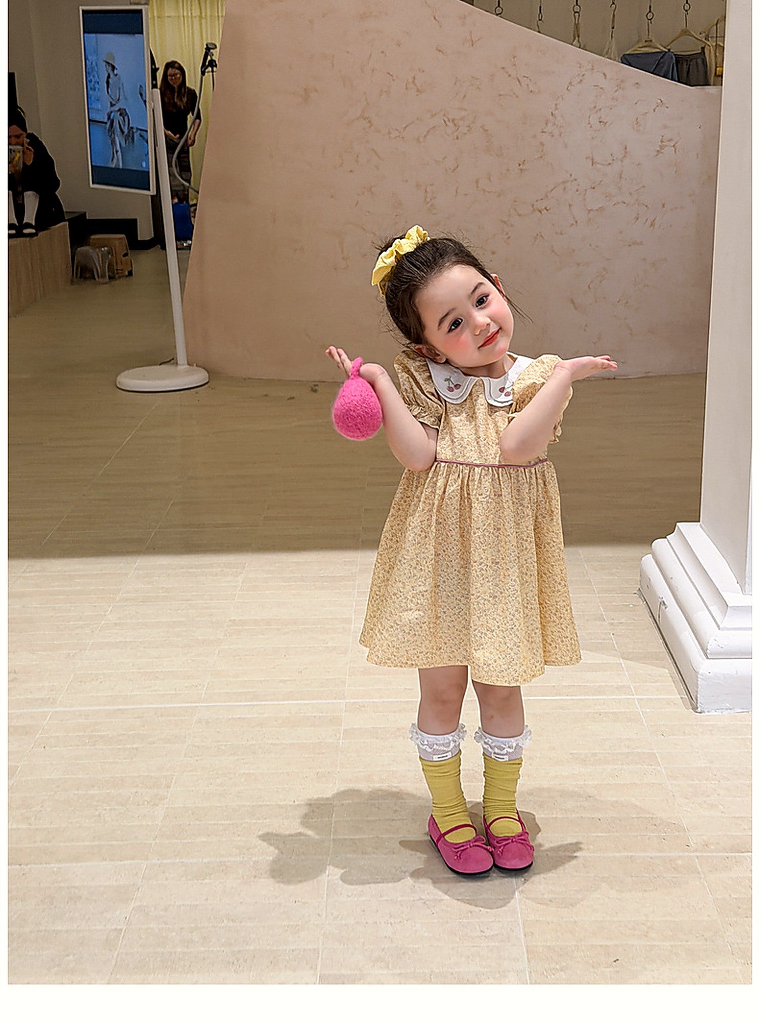 A girl in the Cowslip Dress, a vintage butter-yellow summer dress.