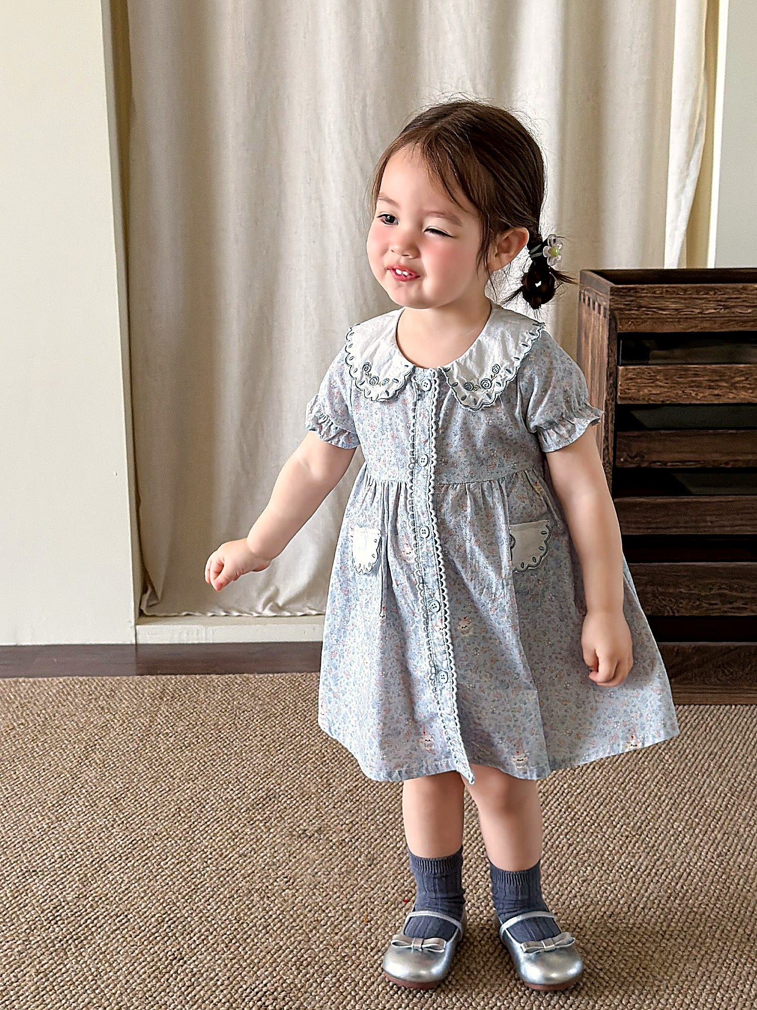 Front of the Forget-me-not Dress — lace collar and short puff sleeves in powder-blue cotton.