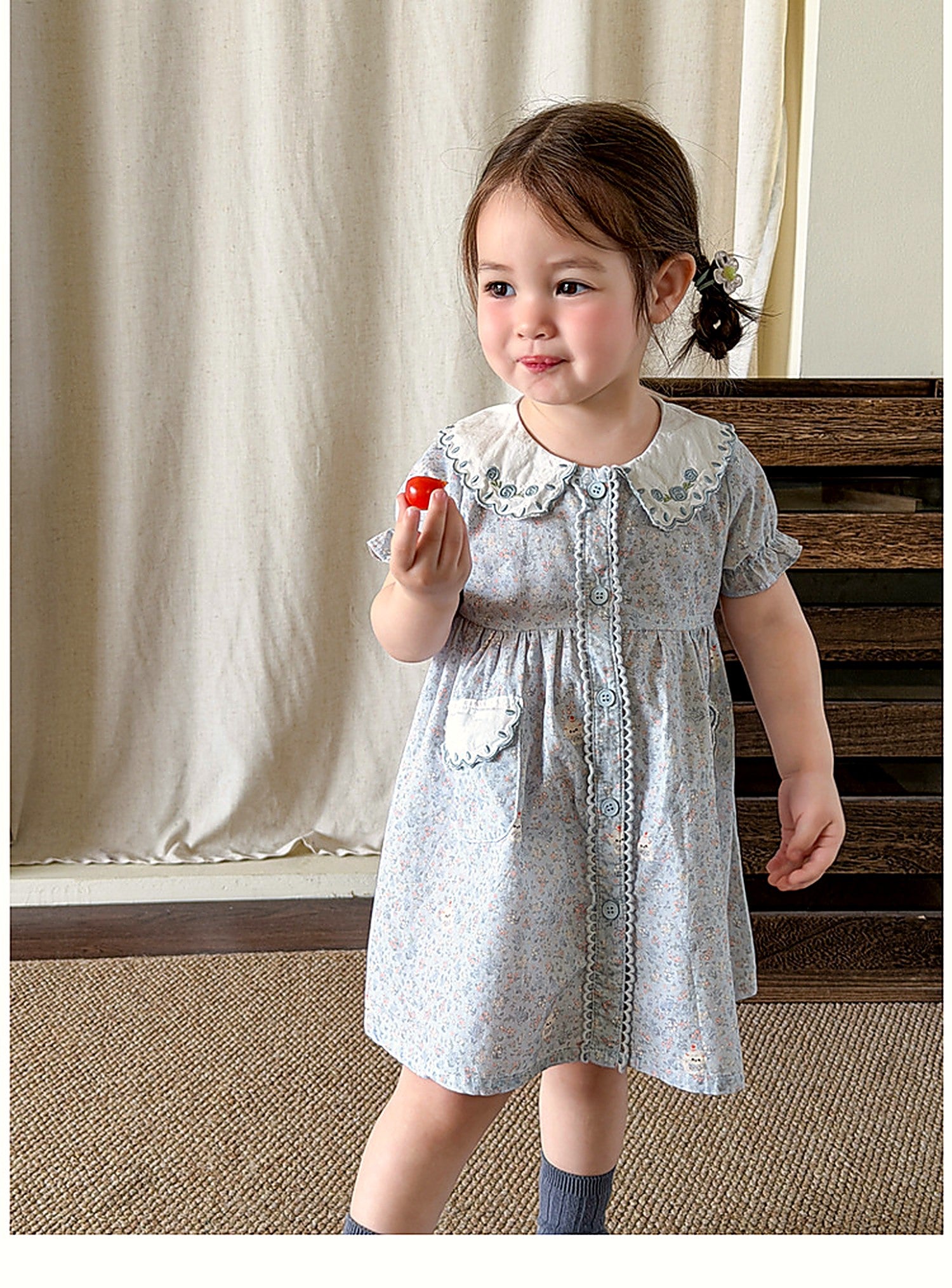 A young girl in the powder-blue Forget-me-not Dress on a warm summer day.