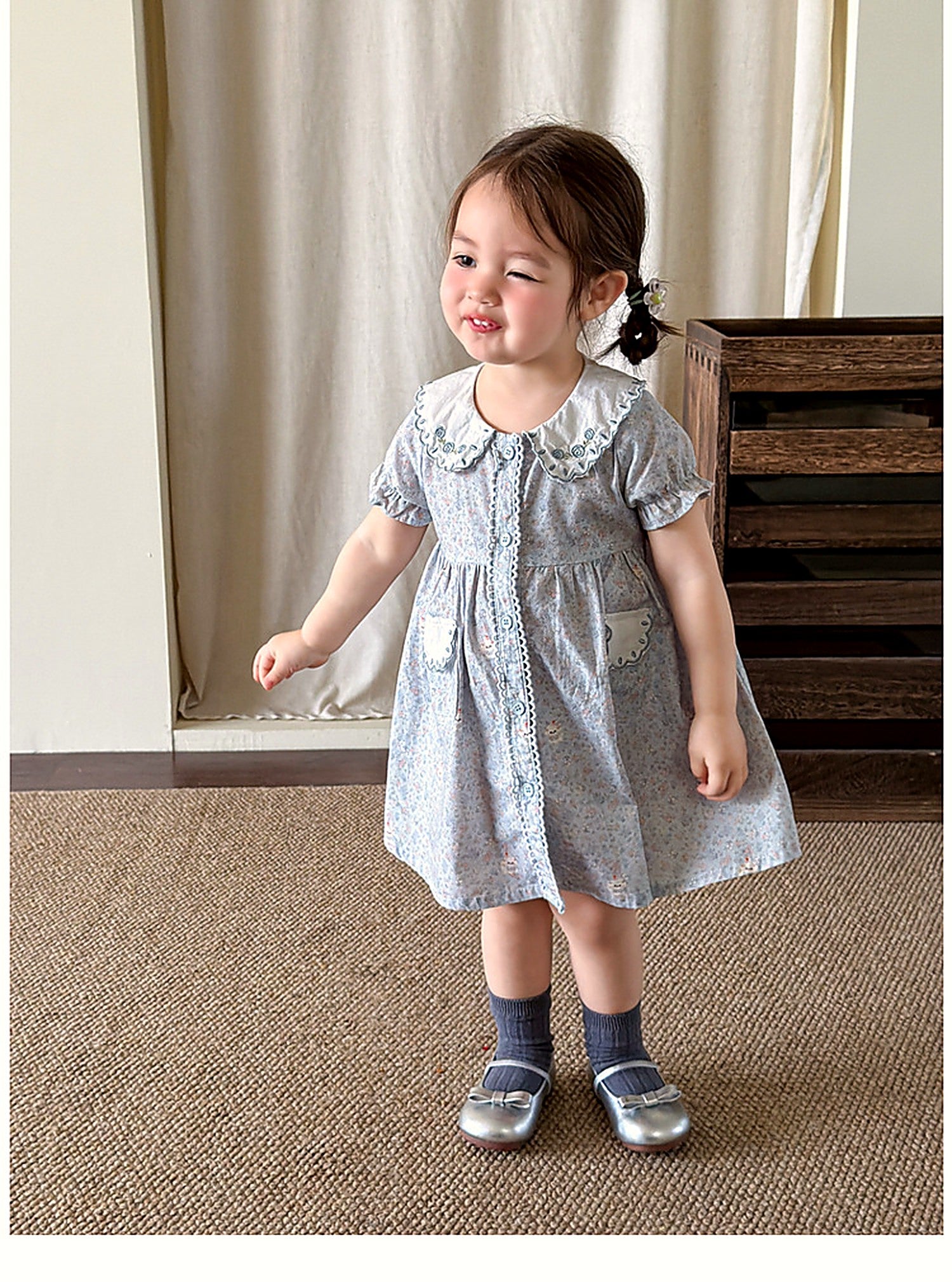 A girl in the Forget-me-not Dress, a vintage powder-blue summer dress.