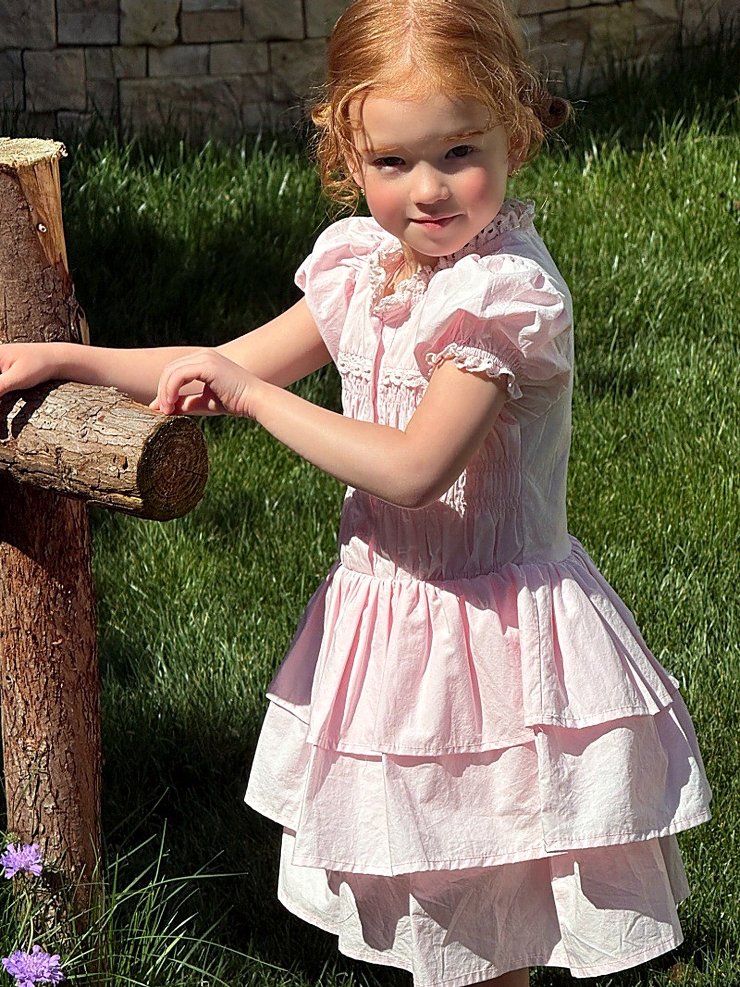 A girl in the pink Foxglove Dress on a warm summer day.