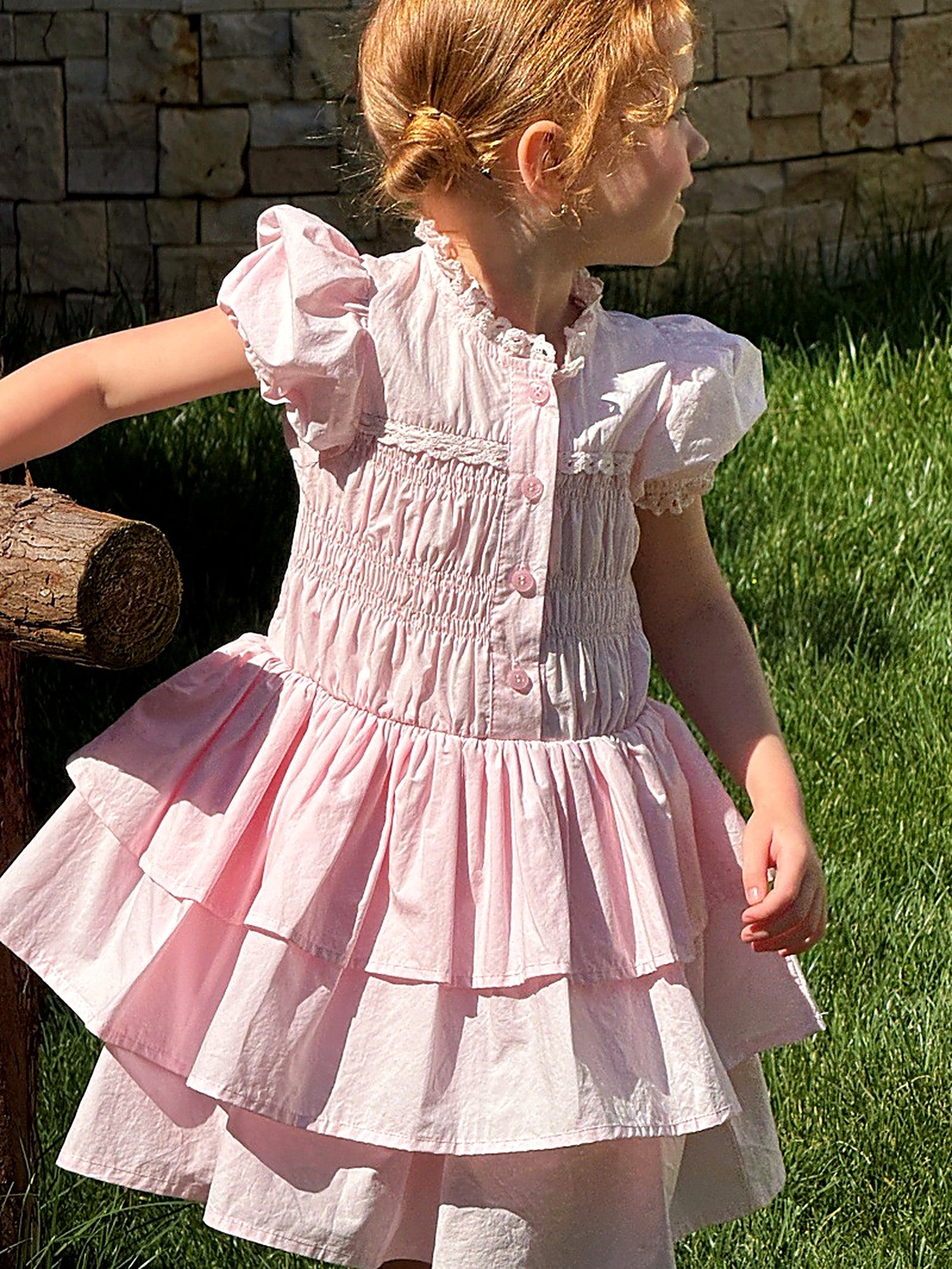The tiered skirt of the Foxglove Dress in washed pink cotton.