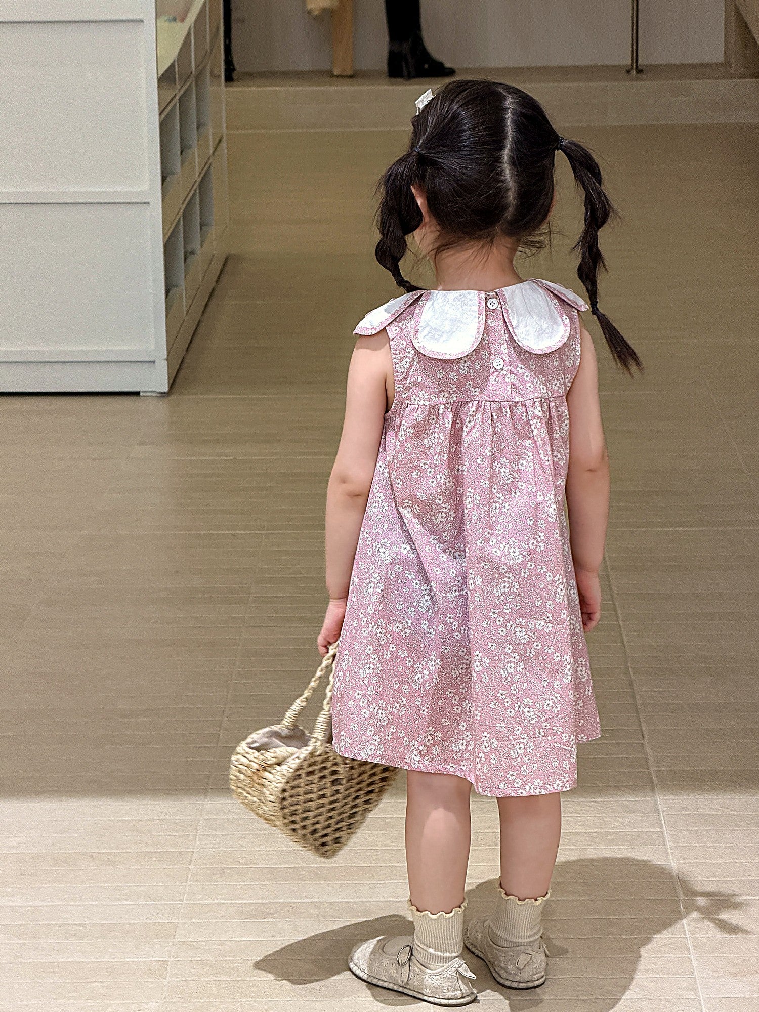 Front of the Hazel Dress — white doll collar, sleeveless, in dusty-pink cotton.