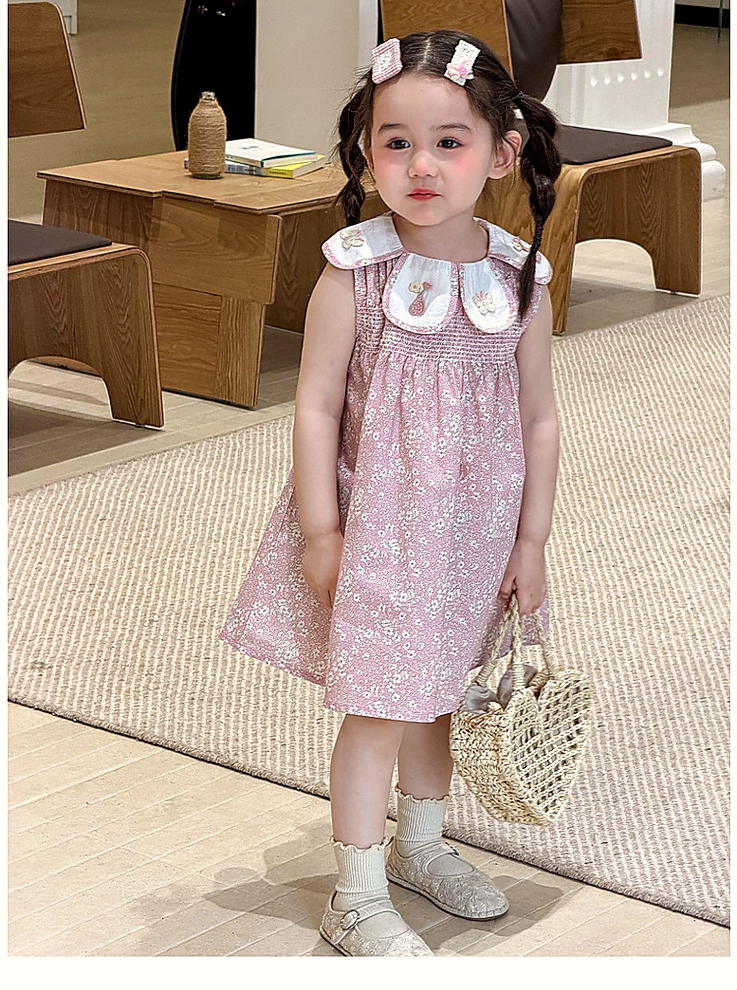 A girl in the Hazel Dress, a vintage dusty-pink summer dress.