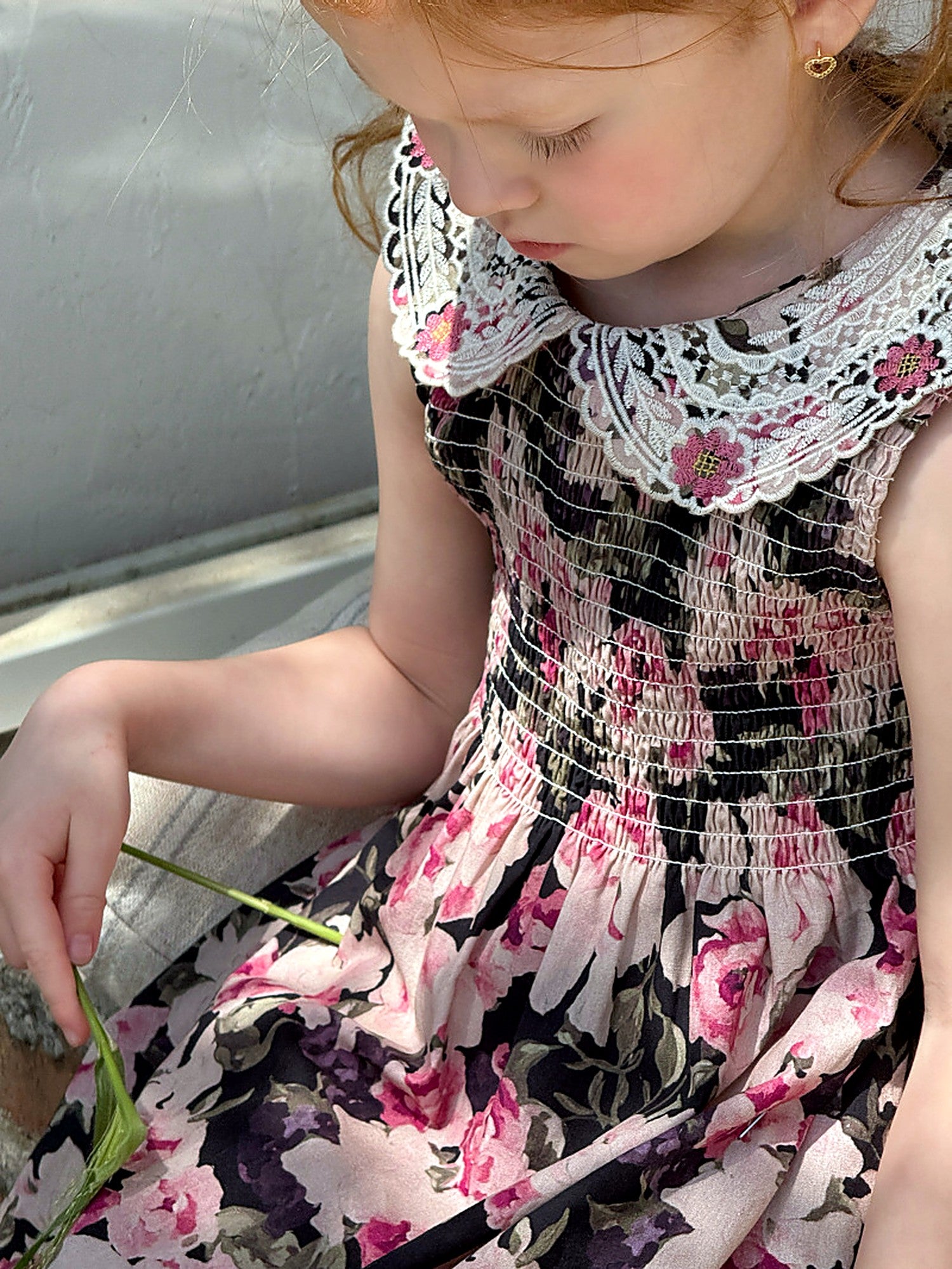 Close detail of the smocked bodice and lace collar of the Hollyhock Dress.