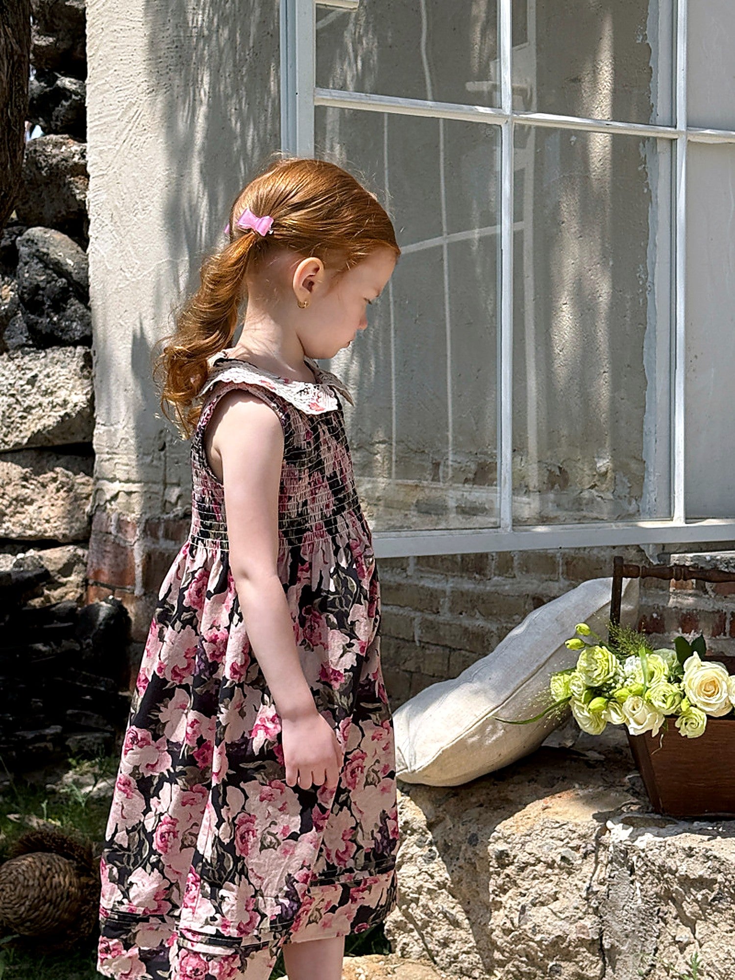 The dark floral print of the Hollyhock Dress skirt.