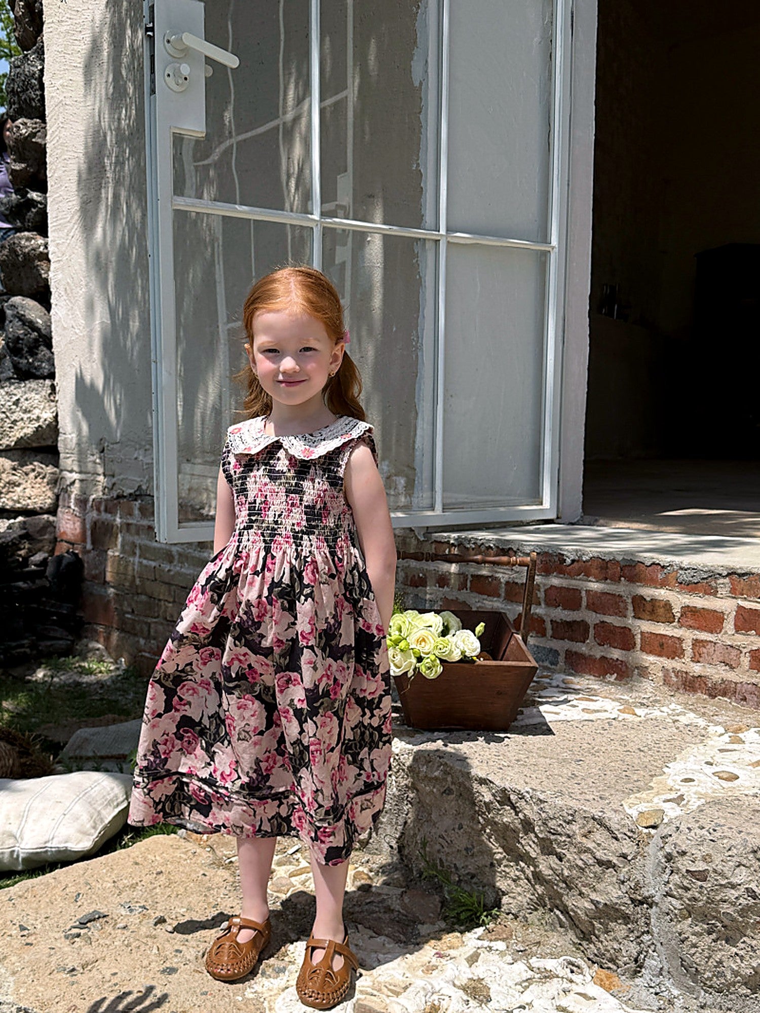 Front of the Hollyhock Dress — lace collar and a deep pink floral print.
