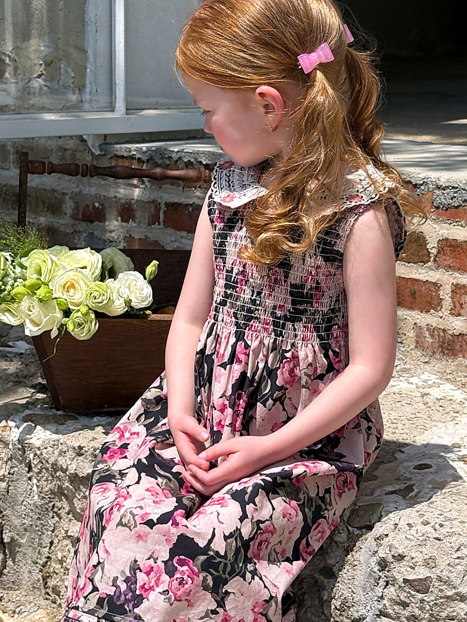 A girl in the Hollyhock Dress, a long vintage floral maxi in dark cotton.