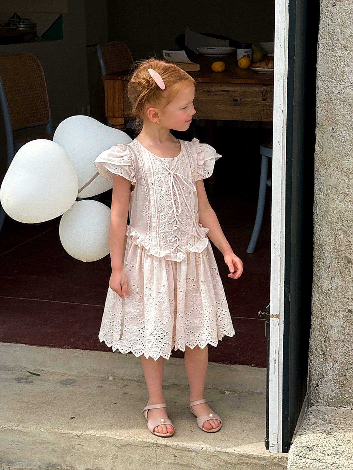 A girl with balloons in the pink Mallow Dress on an unhurried afternoon.