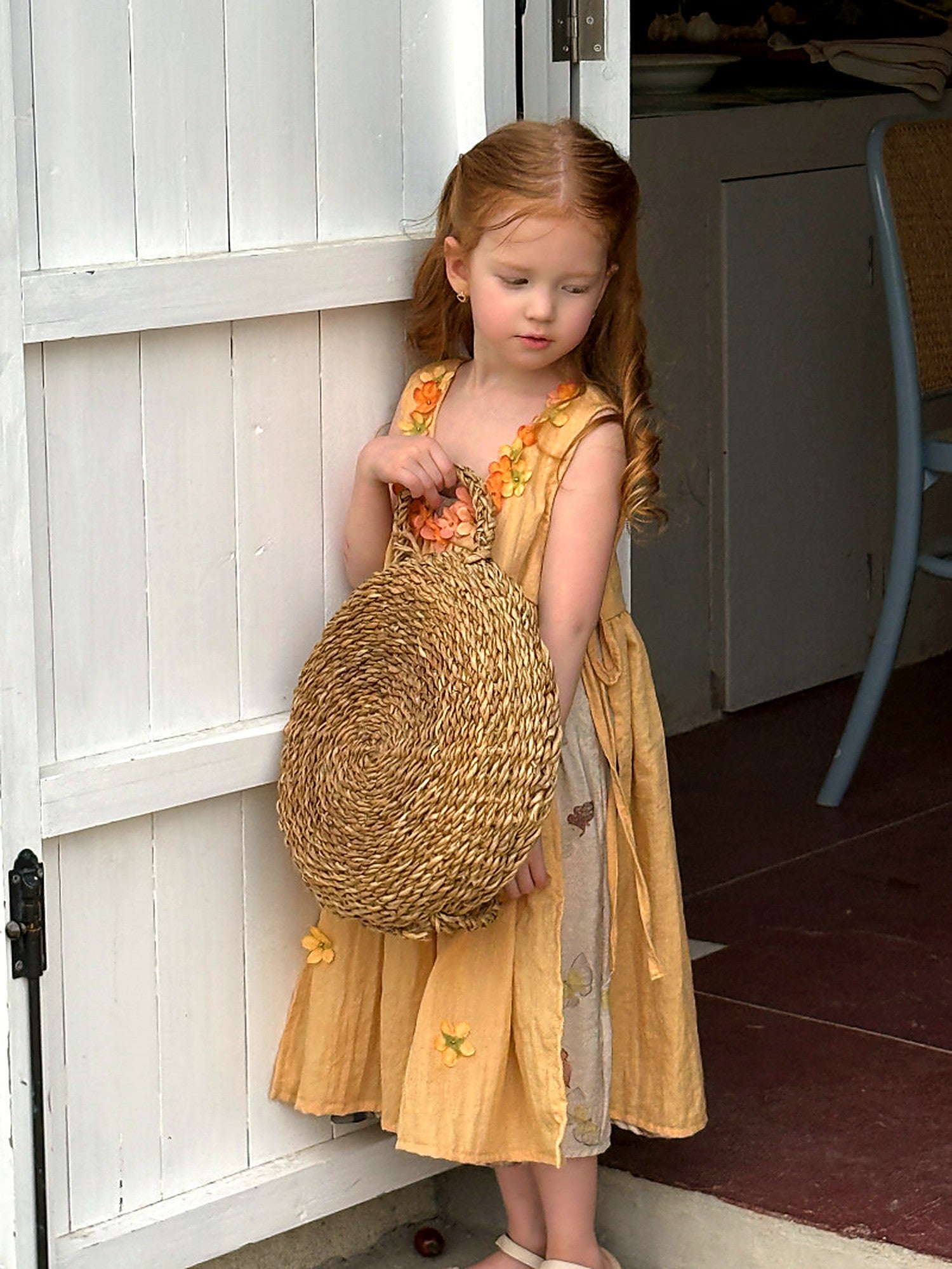 Close detail of the little fabric flowers at the bodice of the Marigold Dress.