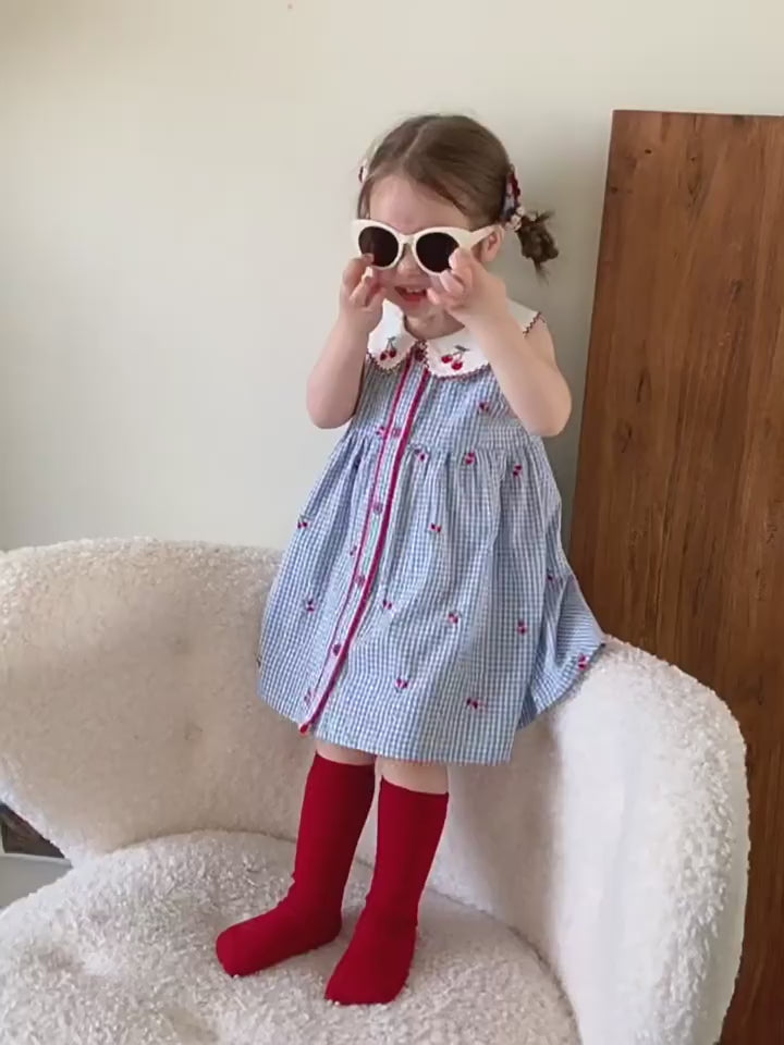 Short film of the Bluebell Pinafore — blue with an embroidered collar, sleeveless and cool.