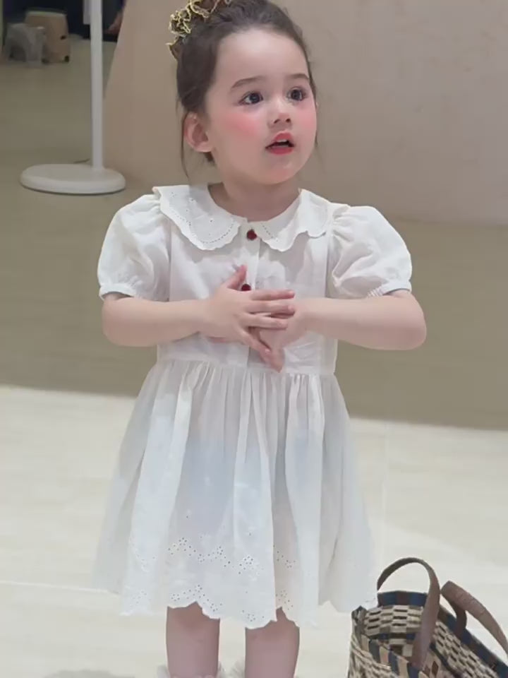 Short film of the Daisy Dress — ivory broderie eyelet, sleeveless and light.