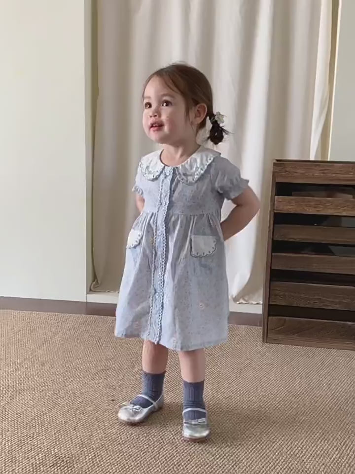 Short film of the Forget-me-not Dress — powder-blue ditsy floral with a doll collar.