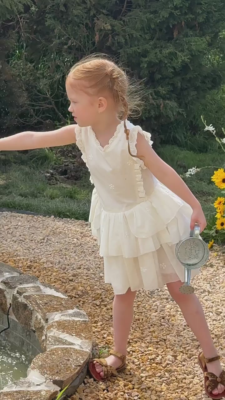 Short film of the Snowdrop Dress — ivory lace tiers, sleeveless and light for summer.