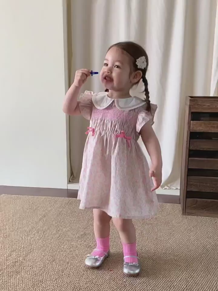 Short film of the Campion Dress — warm-pink with a doll collar and a soft tulle skirt.