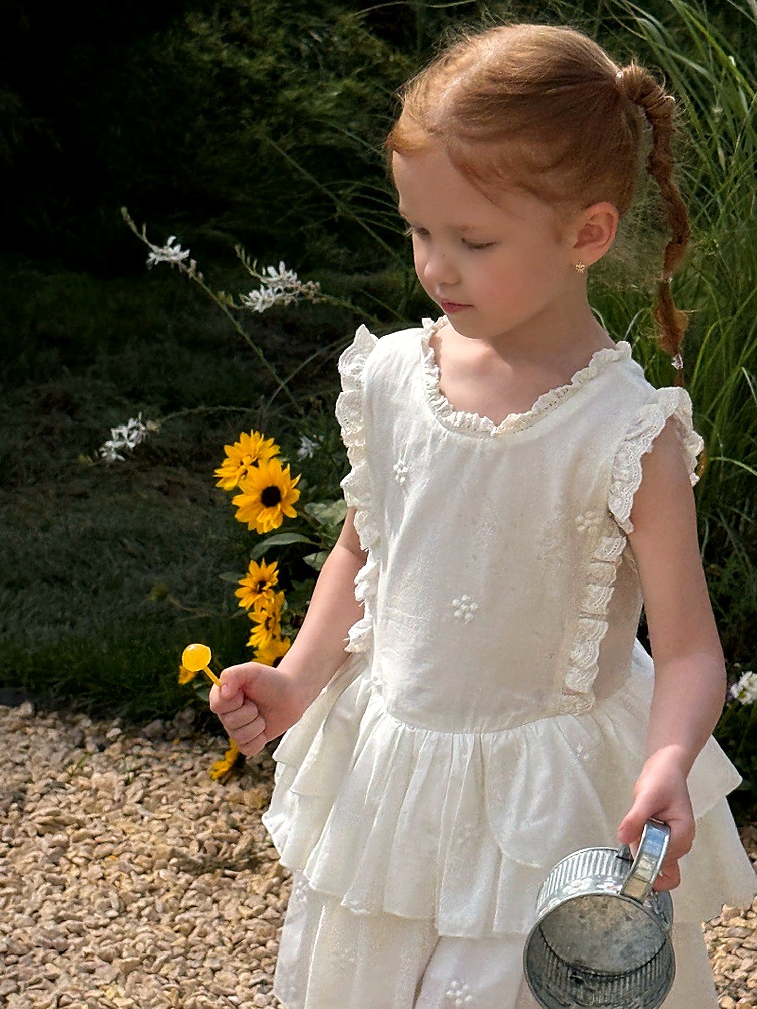 A girl in the white Snowdrop Dress on a warm summer day.