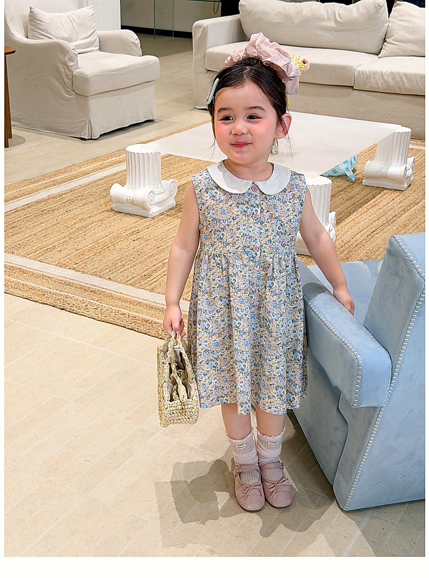 A young girl in the green floral Speedwell Dress on a warm summer day.