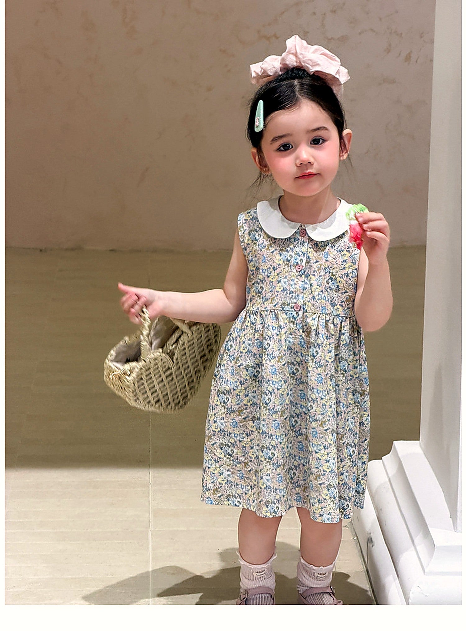 A girl in the sea-mist Speedwell Dress, scattered with tiny flowers.